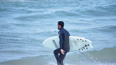 Surfer Running Into Ocean Slowmotion 4k Video stock 77255287