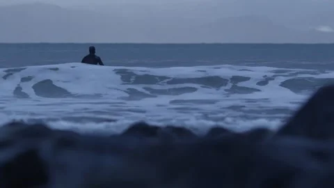Surfer Sitting on Surfboard in the Ocean With Waves Breaking 4k 60fps Stock-Footage 135367608