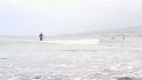 A Surfer Skillfully Riding Waves During Overcast Weather Conditions Stock Footage 316522168