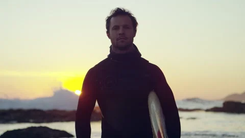 Surfer standing on the beach and looking straight at the camera Stock Footage 279000748