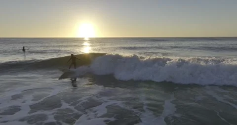 Surfer at Sunset catching a wave at Ocean Beach, San Francisco drone shot Stock Footage 289357359