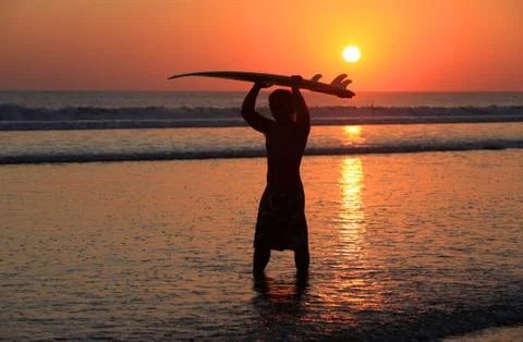 Surfer on sunset Stock Photos
