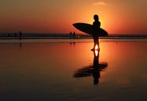 Surfer on sunset Stock Photos