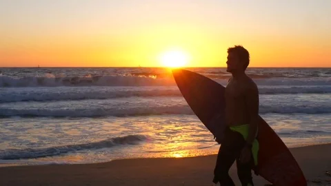 Surfer with surf board running on the beach, California sunset Stock Footage 82947214