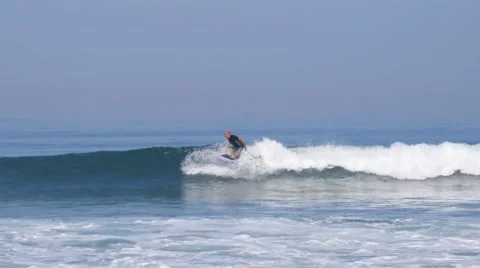 Surfer on Surfboard in Blue Ocean Wave Getting Barreled Stock Footage 65267963
