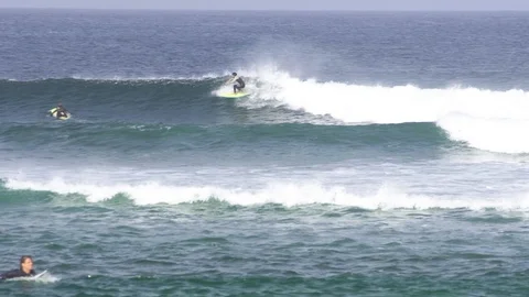 Surfer with surfboard riding on ocean waves 스톡 동영상 85813359