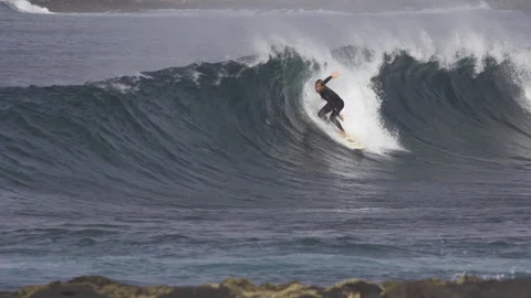 Surfer with surfboard surfing on ocean waves Stock Footage 85813896