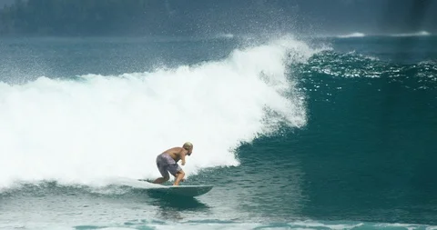 Surfer surfing on the big waves in the turquoise sea in slow motion Stock Footage 85766473