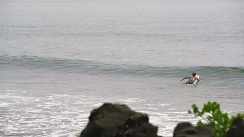 Surfer surfing on a board on the beach in Cameroon, Africa Stock Footage 261582486