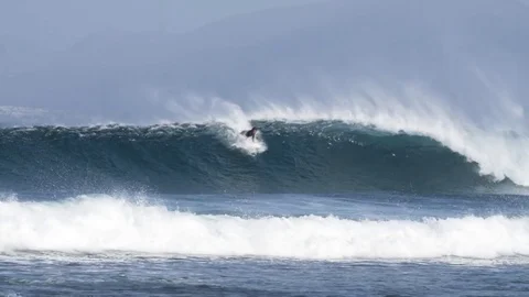 Surfer surfing a giant wave Stock Footage 71537247