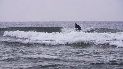 Surfer surfing on waves in slow motion Stock Footage 71564497