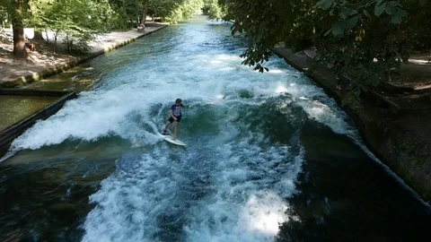 Surfer surfs in the Eisbach River in Munich, Germany Stock-Footage 93712477