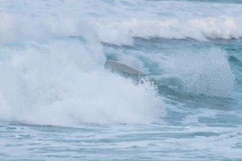 Surfer swallowed by a big wave on a beach on the north coast of Spain Foto stock