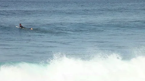 A surfer swimming and floating in the waves Stock Footage 18164826