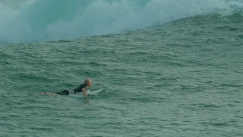 Surfer swimming over waves 1 Stock Footage 86466859