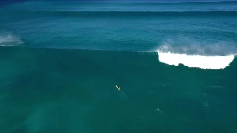 Surfer swims through a huge wave in the Indian Ocean Stock Footage 145256267