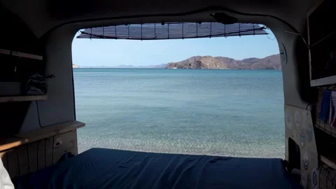 Surfer travel van with back door open to blue clear ocean view, Inside shot Stock Footage 241302114