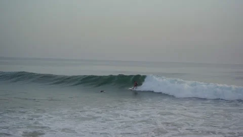 Surfer trying to catch a wave in taghazout anchor point on a half crowded spot Stock Footage 296660302