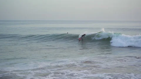 Surfer trying to catch a wave in taghazout anchor point on a half crowded spot Stock Footage 296660531