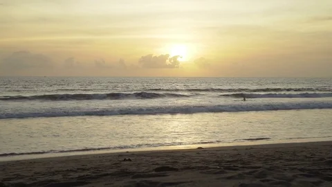 Surfer waiting wave in ocean at sunset Stock Footage 83699564