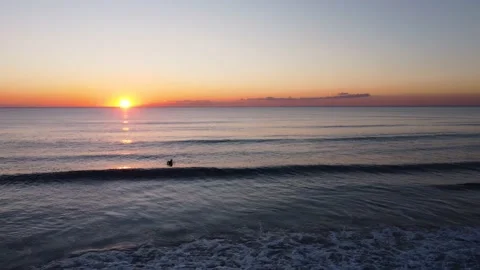 Surfer waiting Waves during Sunset at Costa da Caparica beach, Portugal Stock Footage 146102445