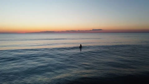 Surfer waiting Waves during Sunset at Costa da Caparica beach, Portugal Stock Footage 146102560