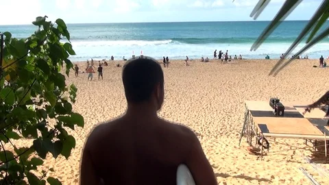 Surfer walk down to the beach Stock Footage 92697389