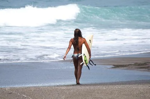 Surfer walking along the beach Stock-Fotos