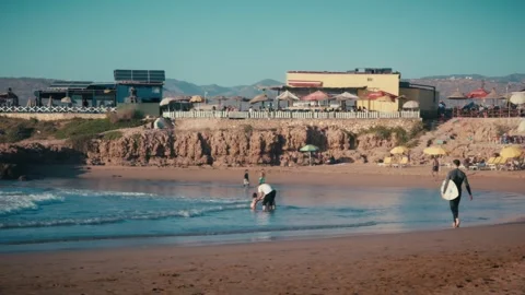 Surfer Walking Along Imourane Beach, Morocco Stock Footage 346316740