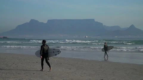 Surfer walking on the beach in Cape Town. South Africa. 30 August 2020 Video stock 159066077