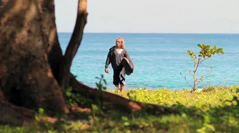 Surfer walking at the beach Stock Footage 26322871
