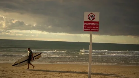 Surfer walking on a beach Stock Footage 82704183