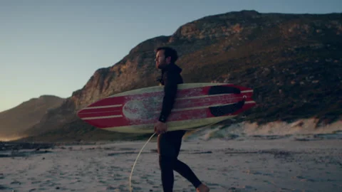 Surfer walking on the beach Stock Footage 279002714