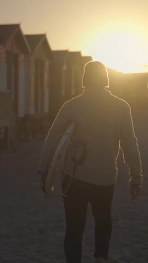 Surfer Walking on Beach at Sunset with Surfboard Stock Footage 326770181