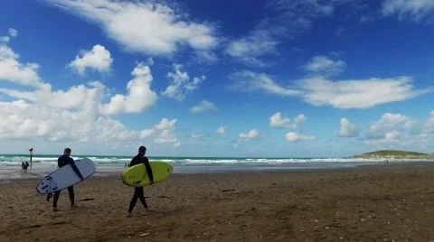 Surfer walking on beach with surf board toward the sea. Stock Footage 65397479