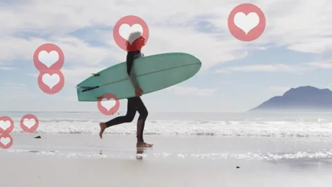 Surfer walking into jogging on beach with board, steps causing social media Stock Footage 333817834