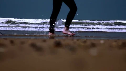 Surfer walking with long surf boards on beach Stock Footage 70731631