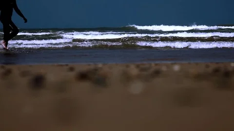Surfer walking with long surf boards on beach Stock Footage 70732311