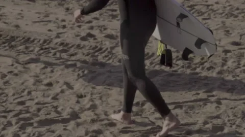 Surfer walking in the sand Stock Footage 239921272