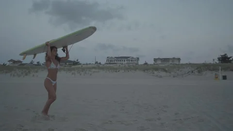 Surfer walking with surfboard Video stock 140360344