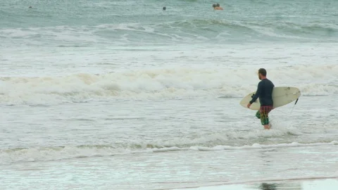 Surfer walking into water Stock Footage 86466382