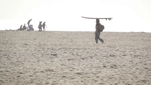 Surfer Walks Along Beach Stock Footage 80354566