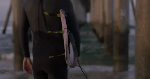 Surfer Walks by Pier Stock Footage 262097906