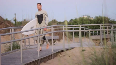 A Surfer Walks Towards The Ocean 動画素材 37727560