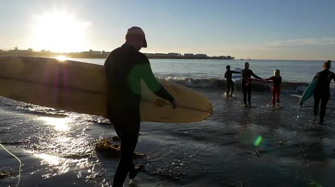 Surfer walks into the water Stock Footage 64228226