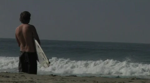 Surfer watching waves Stock Footage 590508