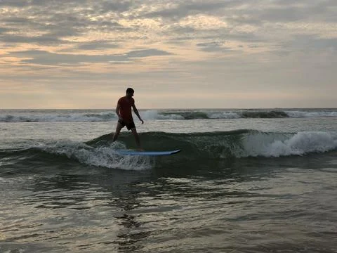 Surfer on the wave. Beginner surfer learned how to ride a board. Waves on the Stock Photos