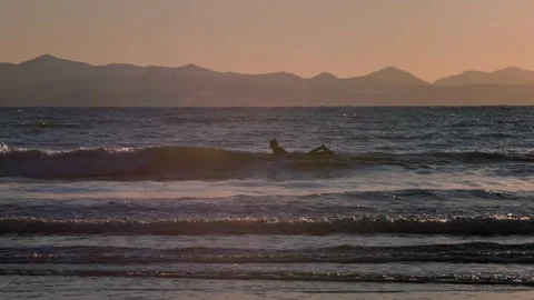 Surfer with waves, sunset ocean, Vancouver Island, West Coast, waves crashing at Stock Footage 168964793