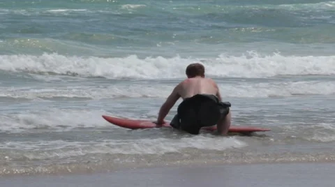 Surfer Waxes Board  Stock Footage 40516756