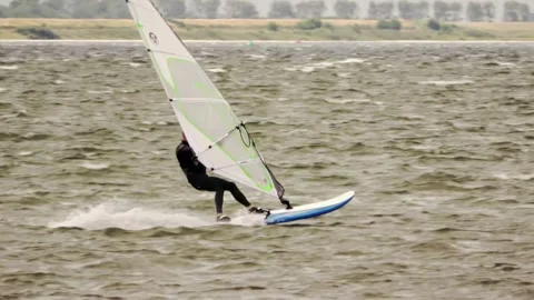 Surfer with white sail in strong wind Video stock 254470188